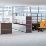 grey and wood paneled cubicles in open office