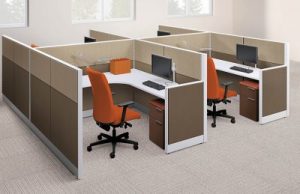 brown office cubicle with desks and orange chairs