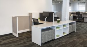 grey cubicle in corner of open office