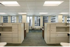 modern office full of tan colored office cubicles