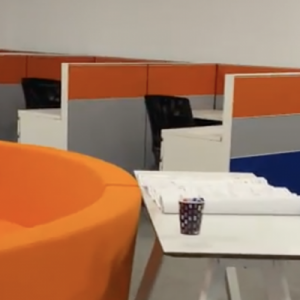 Orange and grey cubicles with chairs