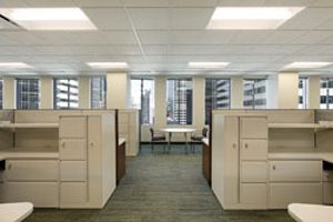 open office with tan cubicles and workstations