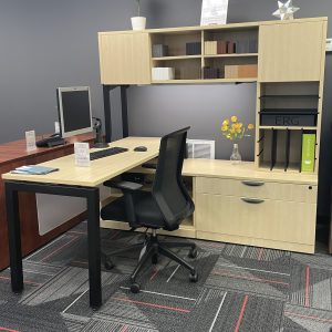 Light wood office furniture in corner